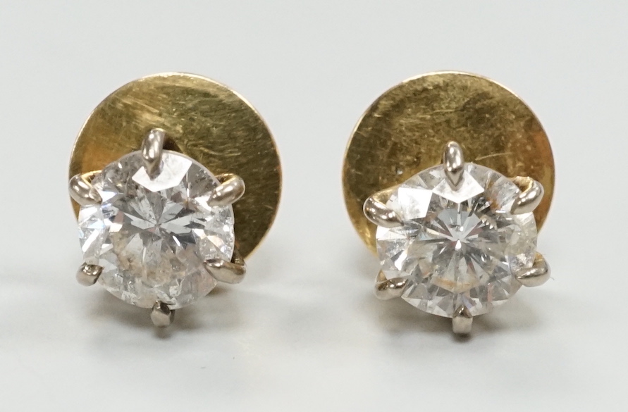A pair of yellow metal (18ct French poincon mark on discs) and solitaire diamond set ear studs